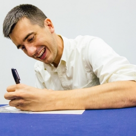 Justin Lamb signs one of his cds @ the UConn Co-op book tour launch. (Tom Kaszuba photo)